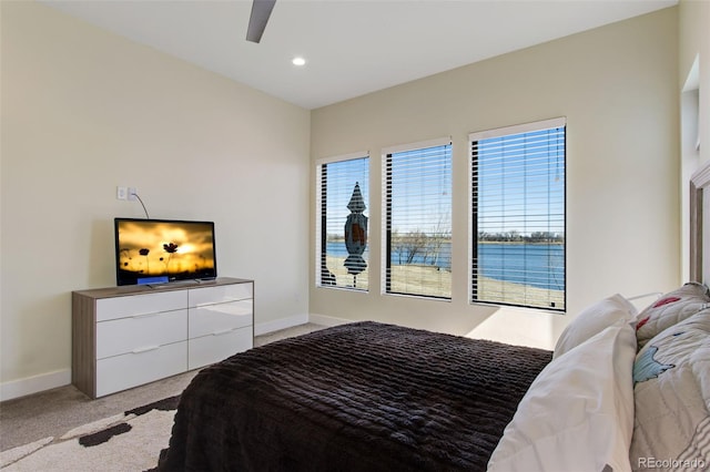 bedroom featuring recessed lighting, light colored carpet, baseboards, and ceiling fan