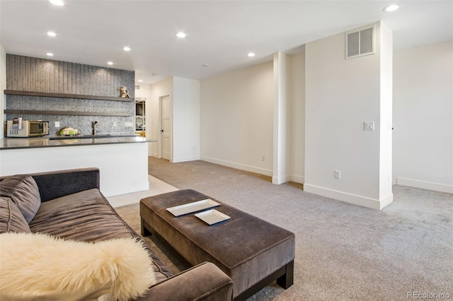 living room with visible vents, recessed lighting, and baseboards