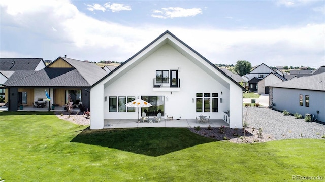 back of house featuring a yard and a patio