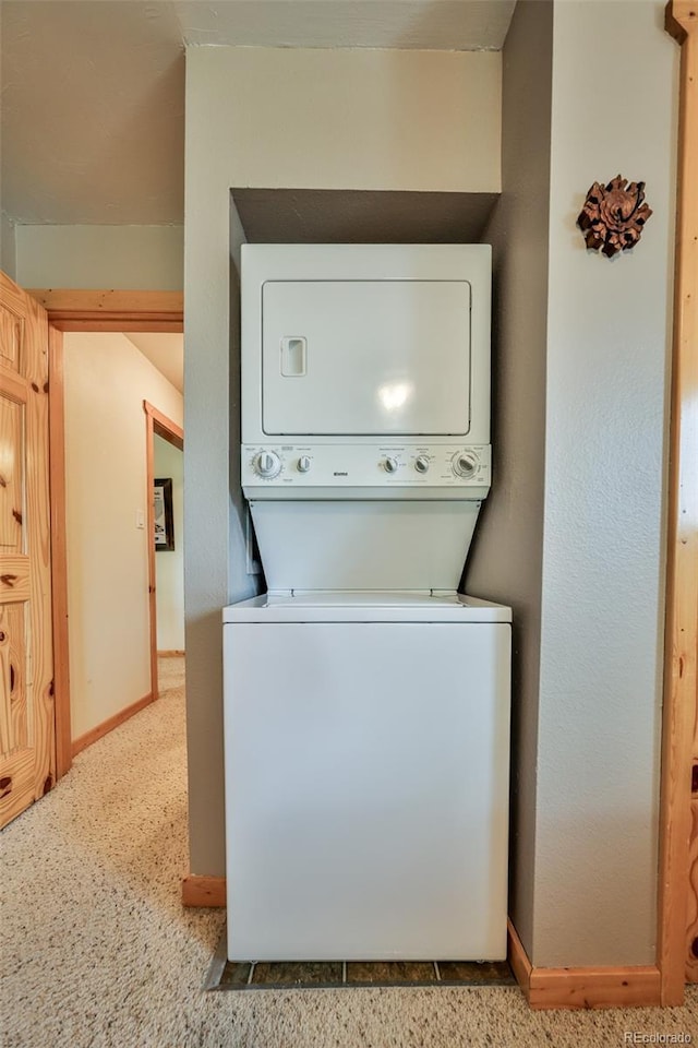 446 Hi Country Drive 17 & 18, Winter Park, CO 80482 - washroom with stacked washing machine and dryer and baseboards