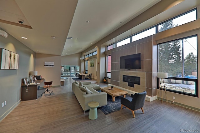 446 Hi Country Drive 17 & 18, Winter Park, CO 80482 - living area featuring wood finished floors, a tiled fireplace, baseboards, and recessed lighting
