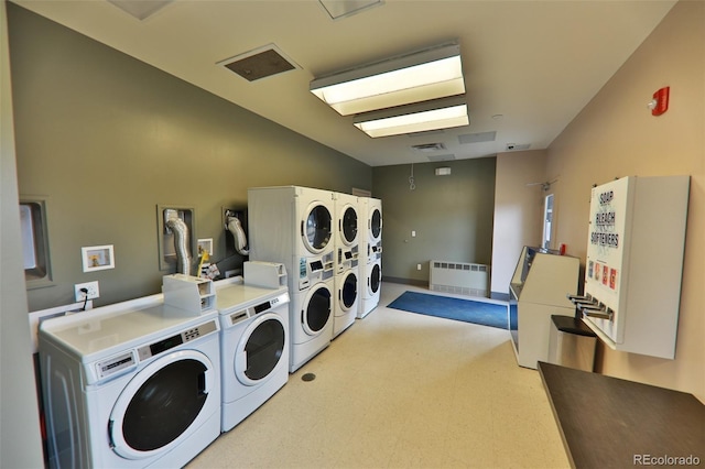 446 Hi Country Drive 17 & 18, Winter Park, CO 80482 - communal laundry room featuring washer and dryer, radiator heating unit, light flooring, and stacked washer / drying machine