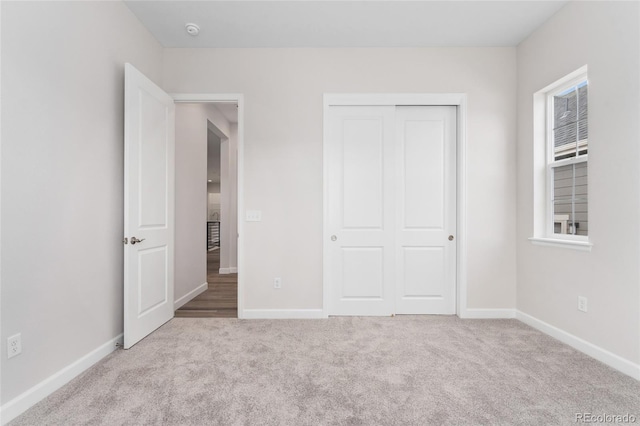 7051 S White Crow Way, Aurora, CO 80016 - unfurnished bedroom with carpet, baseboards, and a closet