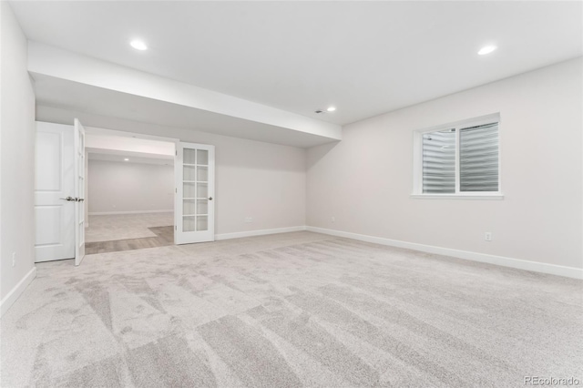 7051 S White Crow Way, Aurora, CO 80016 - finished basement featuring french doors, light colored carpet, baseboards, and recessed lighting