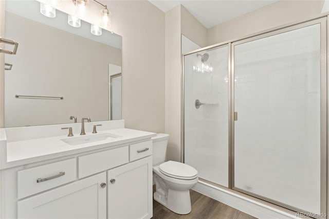 7051 S White Crow Way, Aurora, CO 80016 - bathroom featuring a shower stall, wood finished floors, and toilet