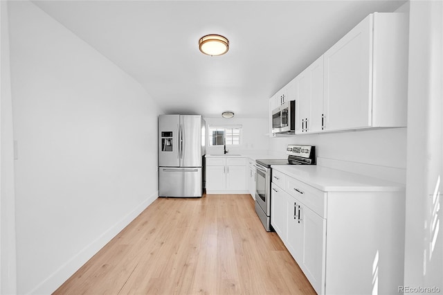3064 S Galapago St, Englewood, CO 80110 - kitchen featuring stainless steel appliances, light wood-style flooring, light countertops, and white cabinets