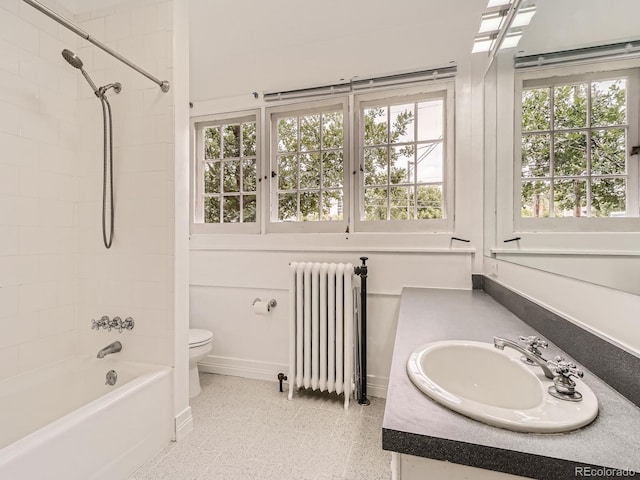 1453 Vine St, Denver, CO 80206 - bathroom featuring radiator heating unit, toilet, vanity, and shower / tub combination