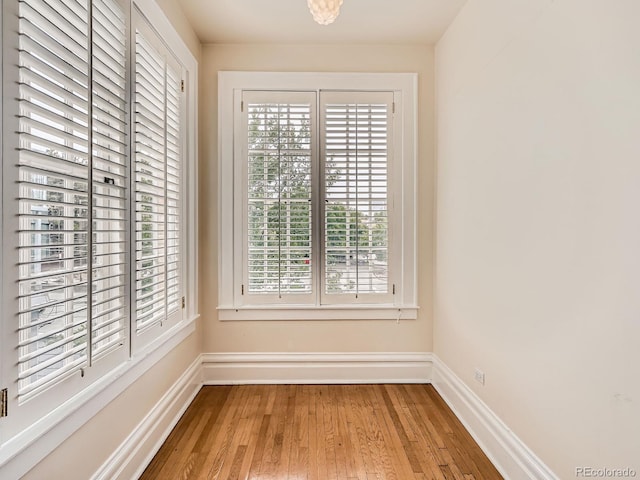 1453 Vine St, Denver, CO 80206 - unfurnished dining area featuring baseboards and wood finished floors