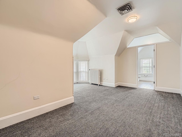 1453 Vine St, Denver, CO 80206 - additional living space with radiator, carpet floors, vaulted ceiling, and baseboards