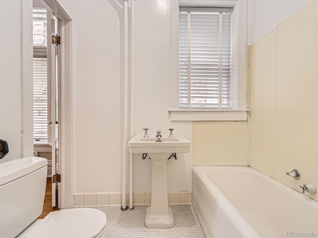 1453 Vine St, Denver, CO 80206 - bathroom with toilet, a bath, plenty of natural light, and tile patterned floors