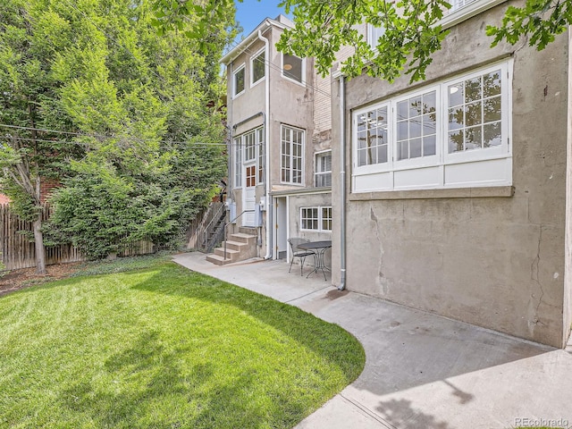 1453 Vine St, Denver, CO 80206 - rear view of house with stucco siding and a patio area