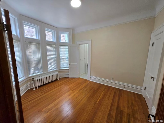 1453 Vine St, Denver, CO 80206 - spare room featuring radiator and light wood-style floors