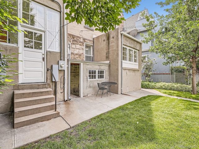 1453 Vine St, Denver, CO 80206 - back of house with entry steps, stucco siding, and a patio area