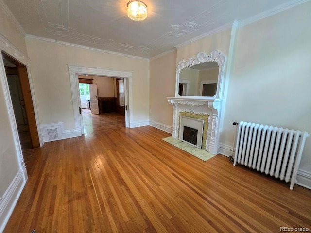 1453 Vine St, Denver, CO 80206 - unfurnished living room with radiator, a fireplace, wood finished floors, and ornamental molding