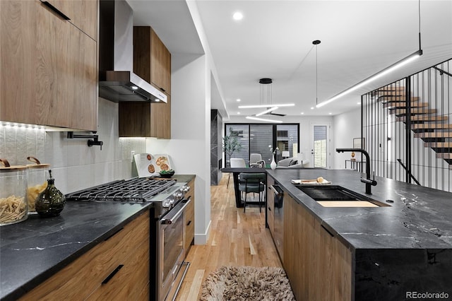 2378 S Bannock St, Denver, CO 80223 - kitchen with wall chimney exhaust hood, appliances with stainless steel finishes, modern cabinets, light wood-style flooring, and recessed lighting