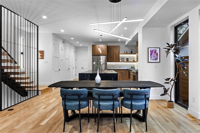 2378 S Bannock St, Denver, CO 80223 - dining area with light wood-type flooring, recessed lighting, and stairway