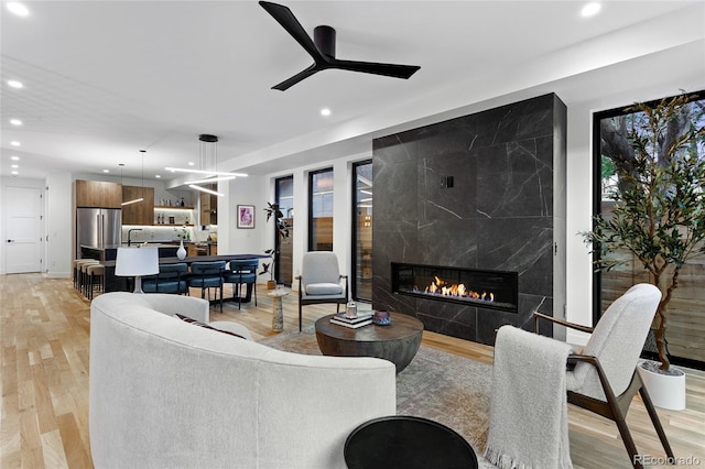 2378 S Bannock St, Denver, CO 80223 - living room with recessed lighting, light wood-style flooring, a high end fireplace, and ceiling fan