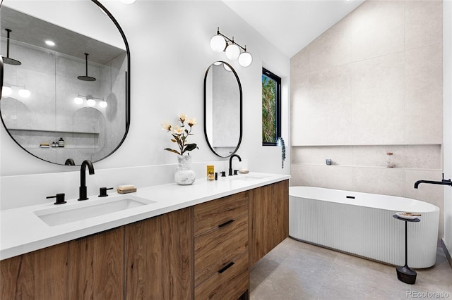 2378 S Bannock St, Denver, CO 80223 - bathroom with a freestanding bath, double vanity, lofted ceiling, and tiled shower
