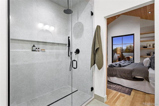 2378 S Bannock St, Denver, CO 80223 - ensuite bathroom with a stall shower, wood finished floors, and vaulted ceiling