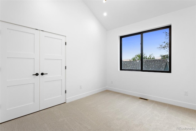 2378 S Bannock St, Denver, CO 80223 - unfurnished bedroom featuring light carpet, recessed lighting, a closet, and high vaulted ceiling