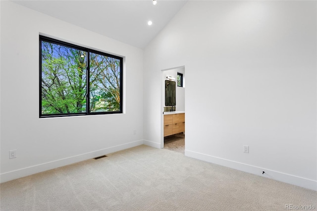 2378 S Bannock St, Denver, CO 80223 - unfurnished room featuring light colored carpet, high vaulted ceiling, and recessed lighting