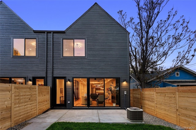 2378 S Bannock St, Denver, CO 80223 - rear view of house with a fenced backyard and a patio