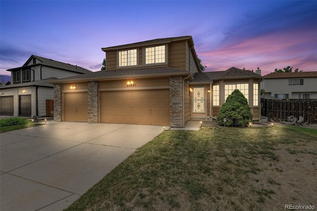 20651 E 42nd Ave, Denver, CO 80249 - traditional-style house featuring concrete driveway, stone siding, a shingled roof, and a garage