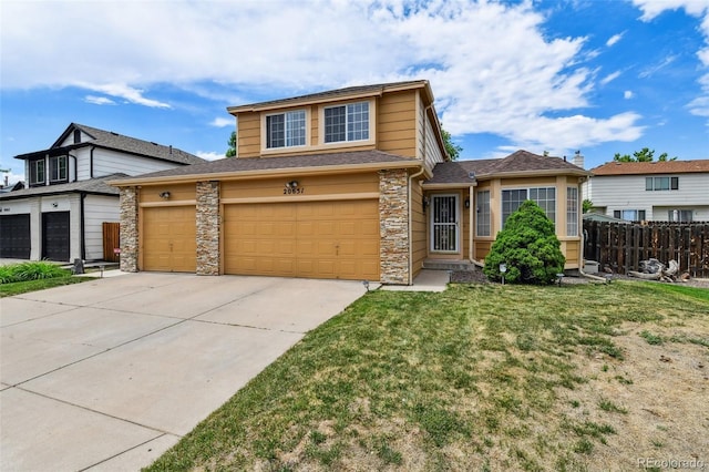 20651 E 42nd Ave, Denver, CO 80249 - view of front of house with driveway, stone siding, and a shingled roof