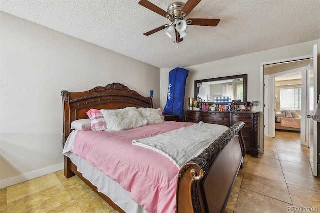 20651 E 42nd Ave, Denver, CO 80249 - bedroom with a textured ceiling, light tile patterned floors, and ceiling fan