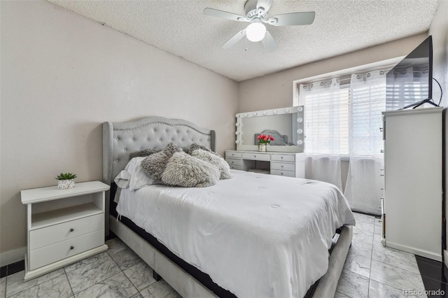 20651 E 42nd Ave, Denver, CO 80249 - bedroom featuring marble finish flooring, a textured ceiling, and a ceiling fan