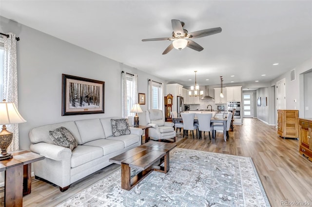9055 Swan River St, Littleton, CO 80125 - living area featuring healthy amount of natural light, ceiling fan, light wood-style flooring, and recessed lighting