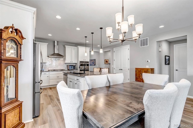 9055 Swan River St, Littleton, CO 80125 - dining space featuring a chandelier, light wood-style floors, and recessed lighting