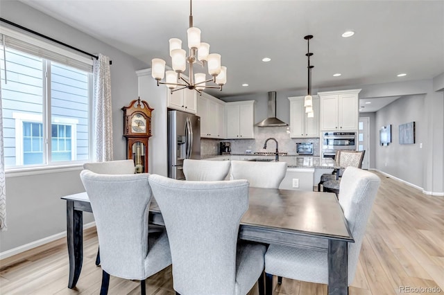 9055 Swan River St, Littleton, CO 80125 - dining area with a chandelier, light wood-style flooring, and recessed lighting