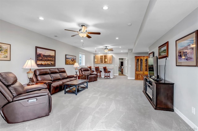 9055 Swan River St, Littleton, CO 80125 - living area featuring light carpet, a ceiling fan, and recessed lighting