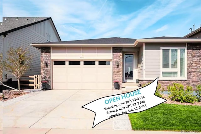 9055 Swan River St, Littleton, CO 80125 - view of front facade with driveway, a garage, and stone siding