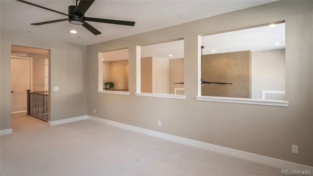 carpeted empty room featuring ceiling fan