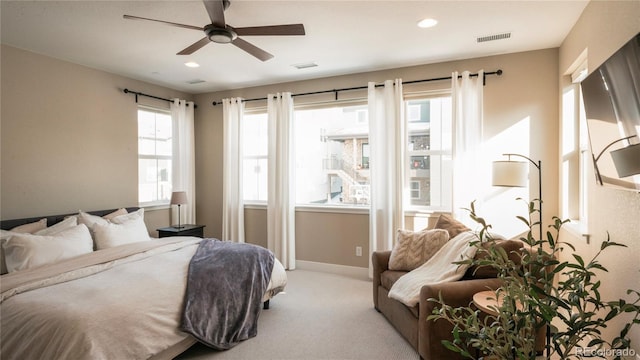 bedroom featuring light carpet and ceiling fan