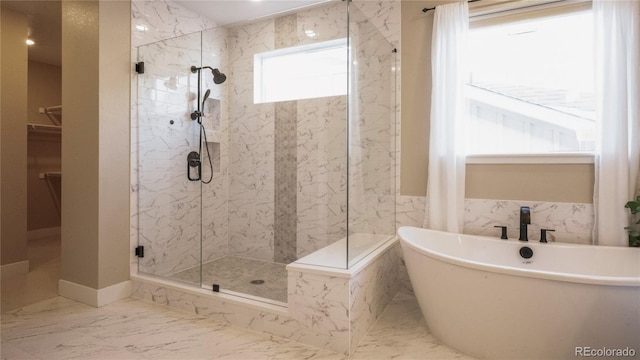 bathroom featuring shower with separate bathtub