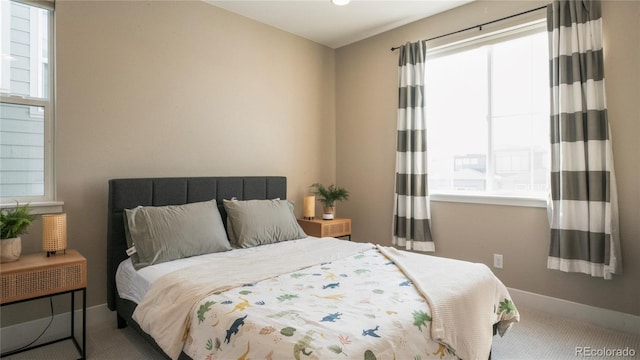 carpeted bedroom featuring multiple windows