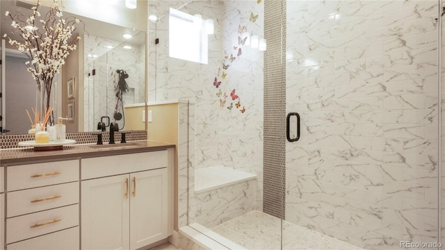 bathroom featuring vanity and an enclosed shower