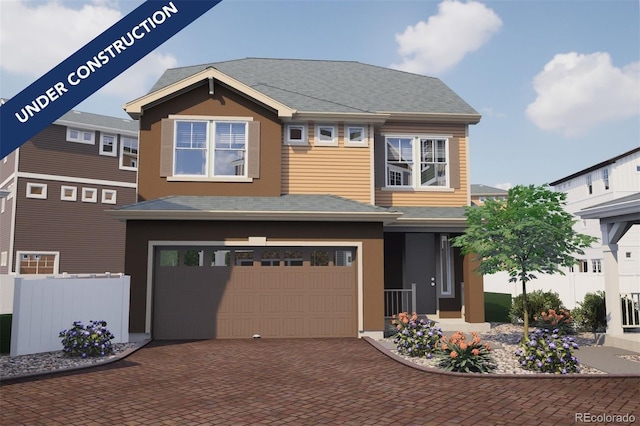 view of front of house featuring decorative driveway, fence, an attached garage, and stucco siding