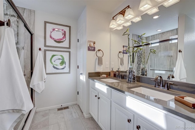 bathroom featuring a sink, visible vents, and a shower stall