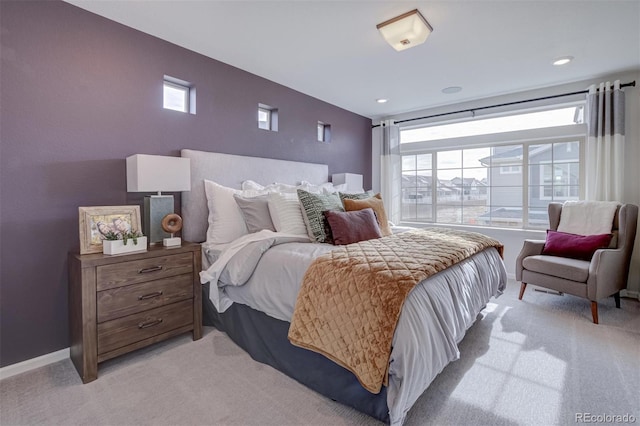 bedroom featuring baseboards and light colored carpet