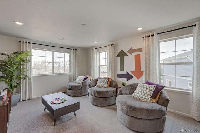 carpeted living room featuring baseboards and recessed lighting