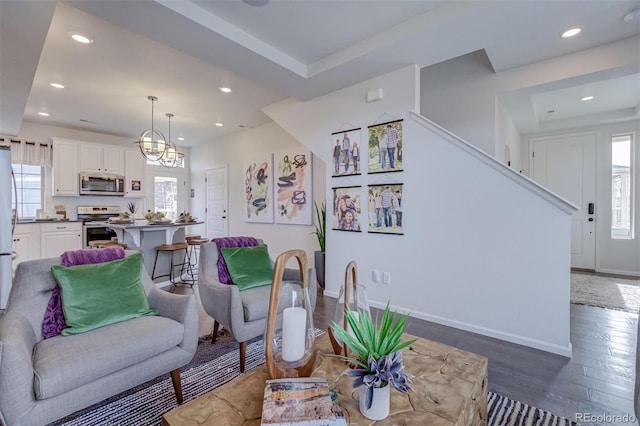 living room with recessed lighting, wood finished floors, and baseboards