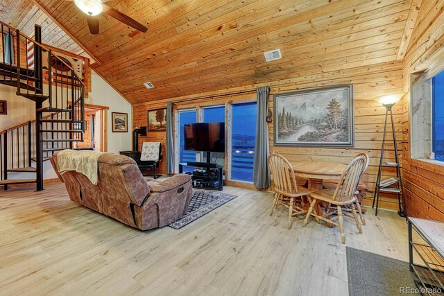 living room with high vaulted ceiling, wood finished floors, stairway, wood walls, and wood ceiling