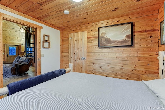 bedroom with wooden walls and wood ceiling