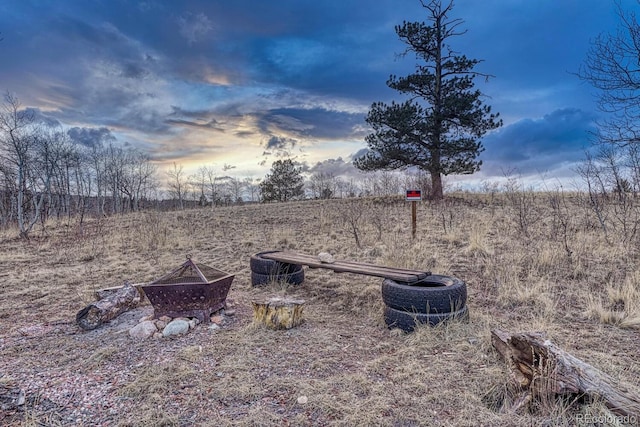 view of yard featuring an outdoor fire pit