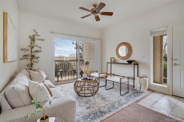 living room featuring a ceiling fan, a healthy amount of sunlight, and light tile patterned floors