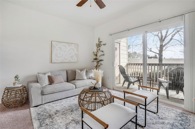 living room with a ceiling fan and carpet flooring